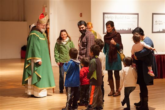 Cardinal O'Malley greets a family at New York Encounter. Photo by Emily Marsolek 