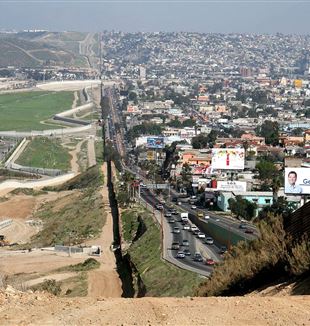 Fence separating Mexico from the United States. Photo by Sgt. Gordon Hyde via Wikimedia Commons