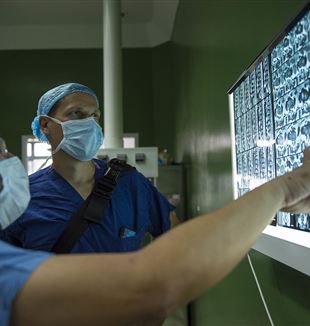 Neurosurgeons Examining X-Rays. Wikimedia Commons