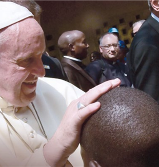 Pope Francis visiting a refugee camp in Bangui. Traces
