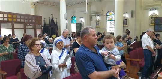 Christians praying in the Church of the Holy Family in Gaza during the conflict